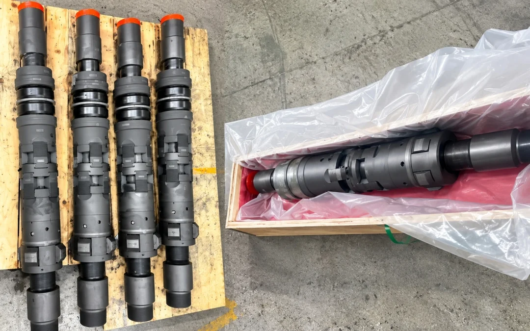 Customized packer assemblies on a wooden pallet, with another assembly packed in a lined wooden crate.